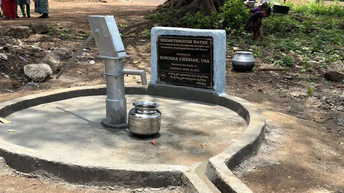 A completed Breakthrough Water hand pump with its project plaque.